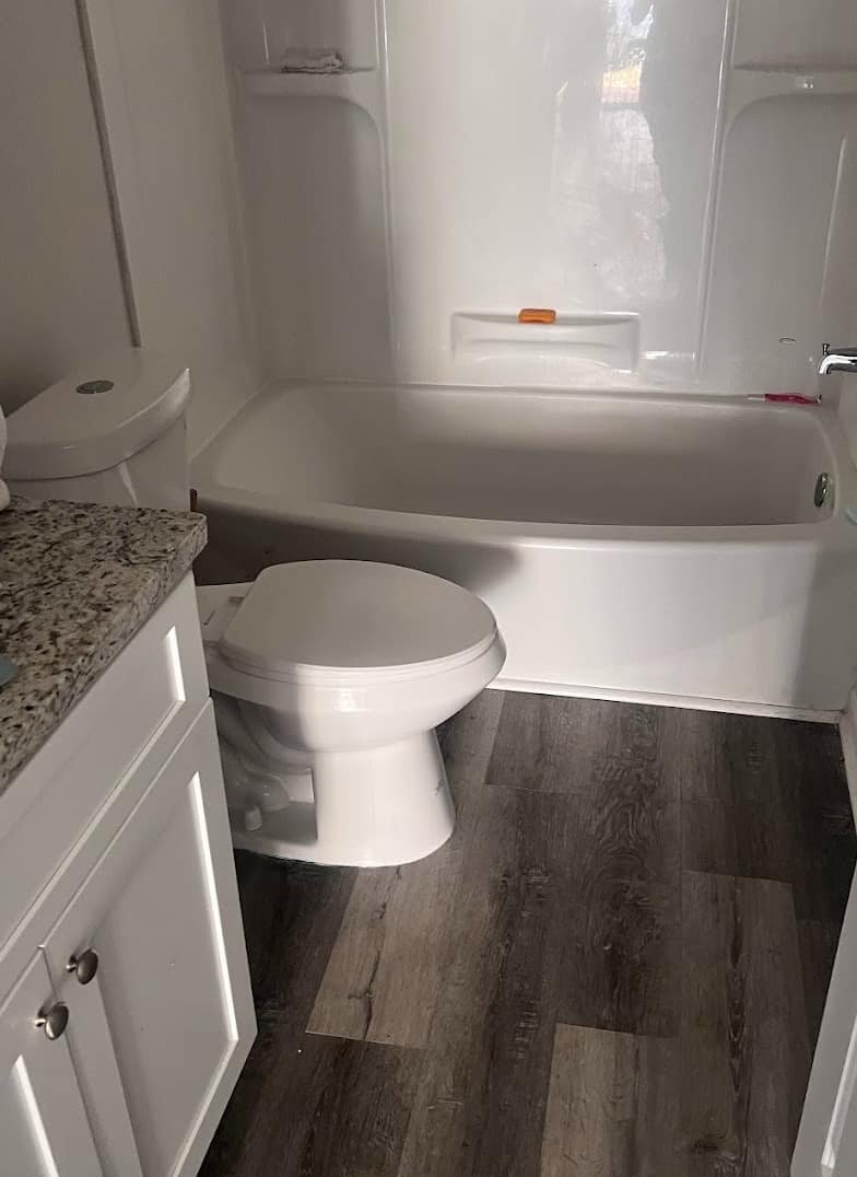 Bathroom with a newly installed toilet and bathtub